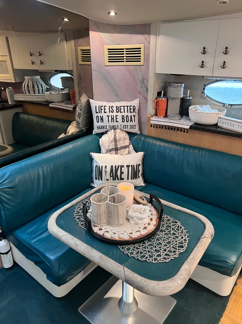 Slide: The Image of Interior of a 1992 Wellcraft 43 Portofino boat with cozy seating and decorative pillows. - 10