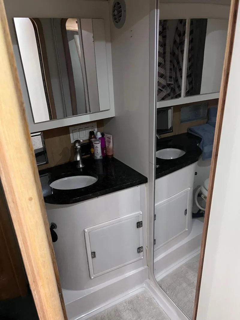 Slide: The Image of Bathroom interior of 1992 Wellcraft 43 Portofino yacht with mirrored cabinets and sink. - 12