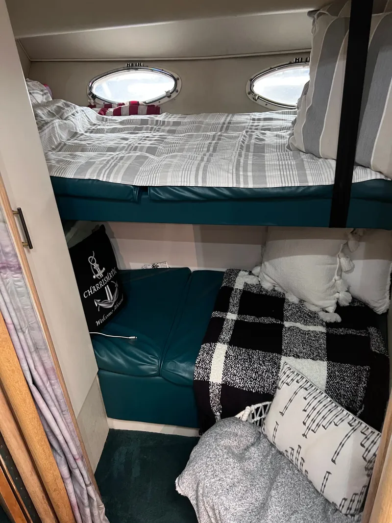 Slide: The Image of Cozy cabin interior of 1992 Wellcraft 43 Portofino with bunk beds and nautical decor. - 13