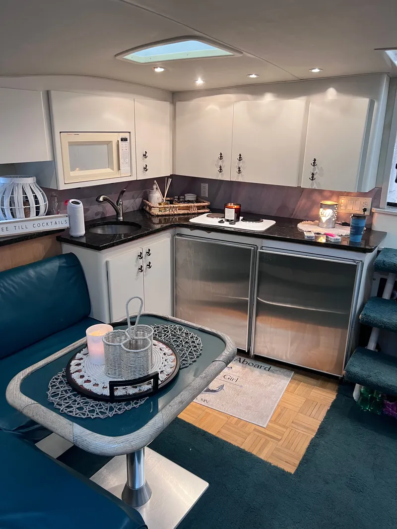 Slide: The Image of Luxurious 1992 Wellcraft 43 Portofino yacht interior with modern kitchen and cozy seating area. - 9