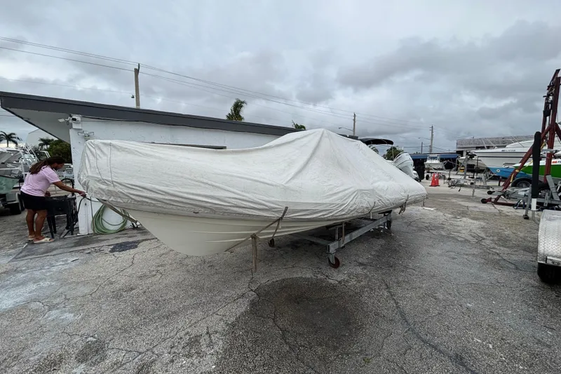 Slide: The Image of Covered 2019 Brig Eagle 650 boat on trailer in a marina setting. - 10