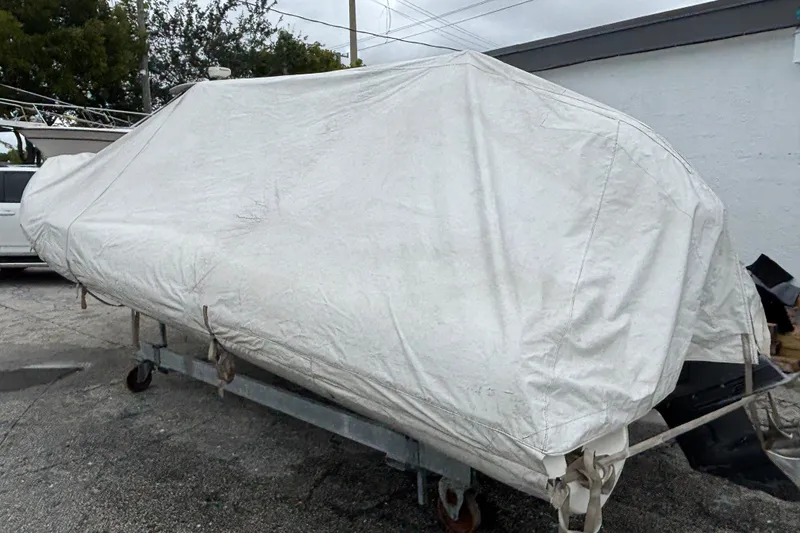Slide: The Image of 2019 Brig Eagle 650 boat covered with a protective tarp on a trailer. - 11