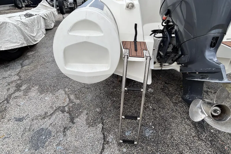Slide: The Image of 2019 Brig Eagle 650 boat with ladder and outboard motor on asphalt surface. - 13