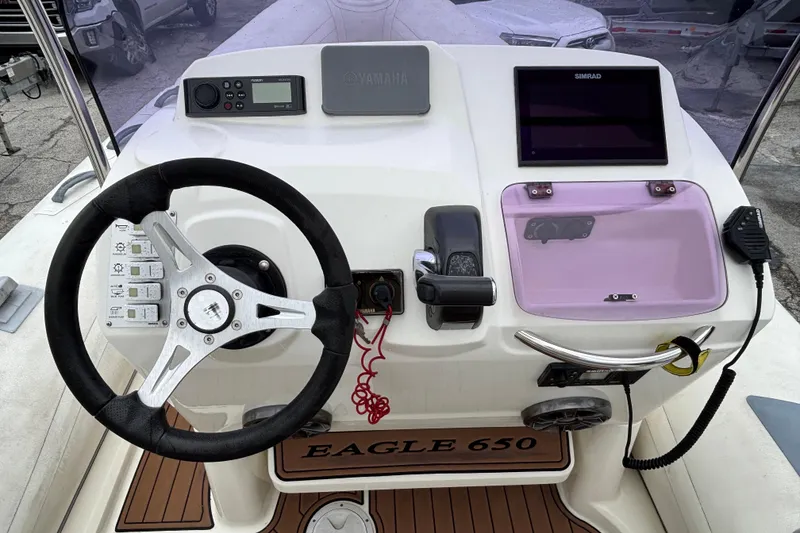 Slide: The Image of 2019 Brig Eagle 650 boat dashboard with steering wheel and navigation controls. - 3