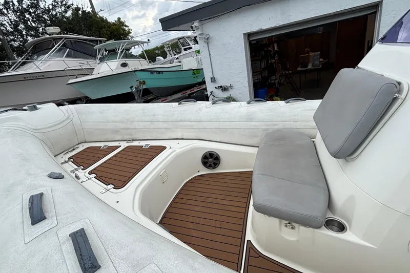 Slide: The Image of 2019 Brig Eagle 650 boat interior with cushioned seating and wooden deck flooring. - 6