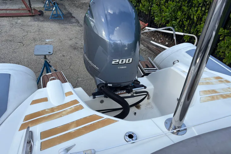 Slide: The Image of 2019 Brig Eagle 650 boat with Yamaha 200 outboard motor, docked on pavement. - 7