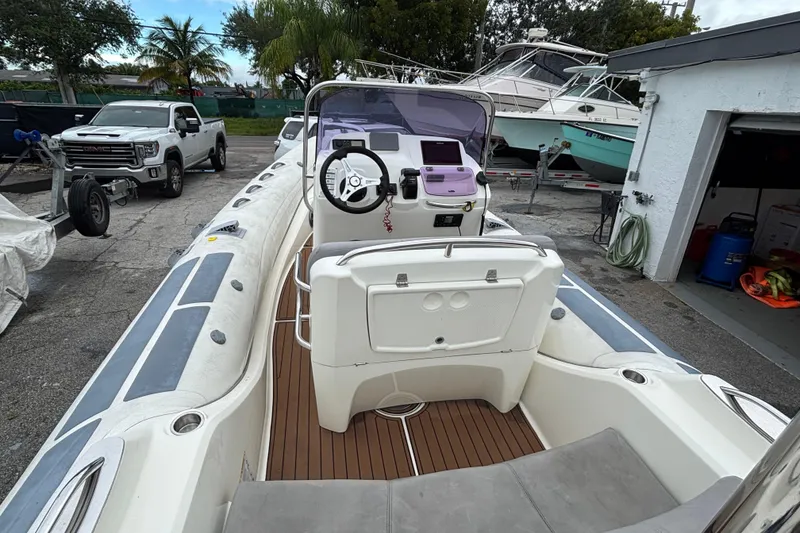 Slide: The Image of 2019 Brig Eagle 650 boat with sleek design, parked near other boats and a truck. - 8
