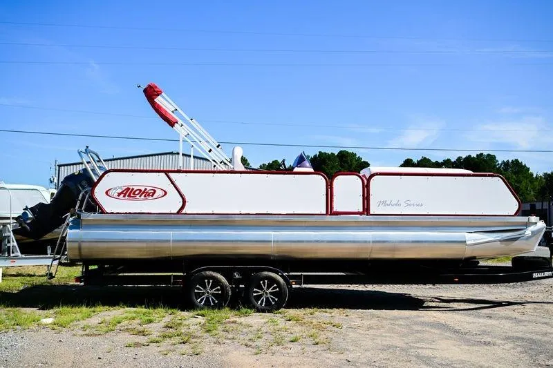 The Image of 2023 Aloha Pontoon Mahalo 23 boat on trailer, side view, outdoors. - 0
