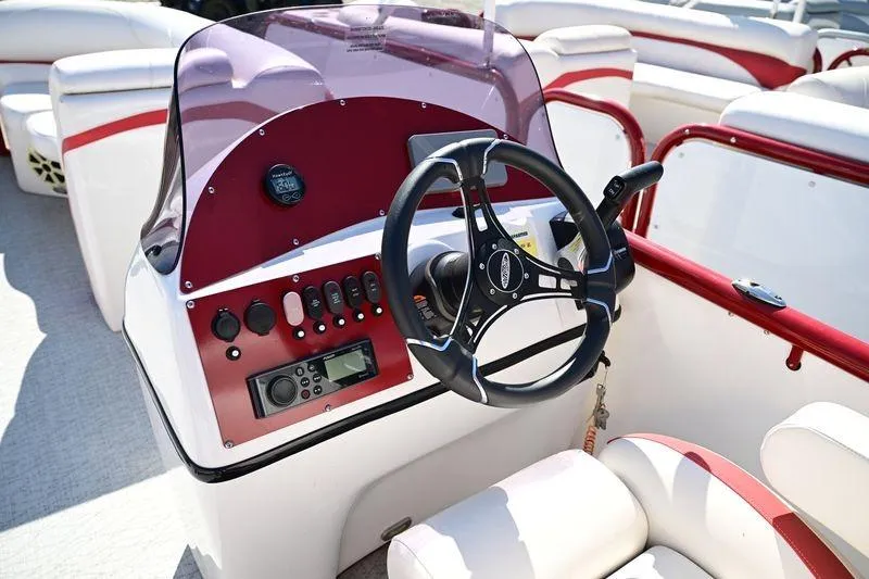 Slide: The Image of 2023 Aloha Pontoon Mahalo 23 boat dashboard with steering wheel and controls. - 10