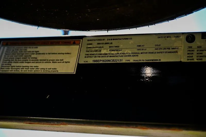 Slide: The Image of Label on Aloha Pontoon Mahalo 23, 2023 model, showing manufacturing details and specifications. - 13