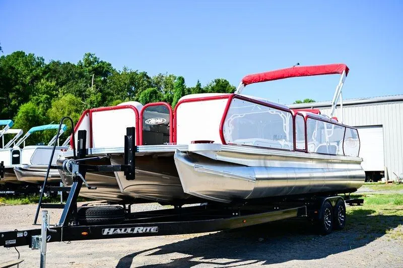 Slide: The Image of 2023 Aloha Pontoon Mahalo 23 on trailer, featuring red canopy and sleek design. - 3