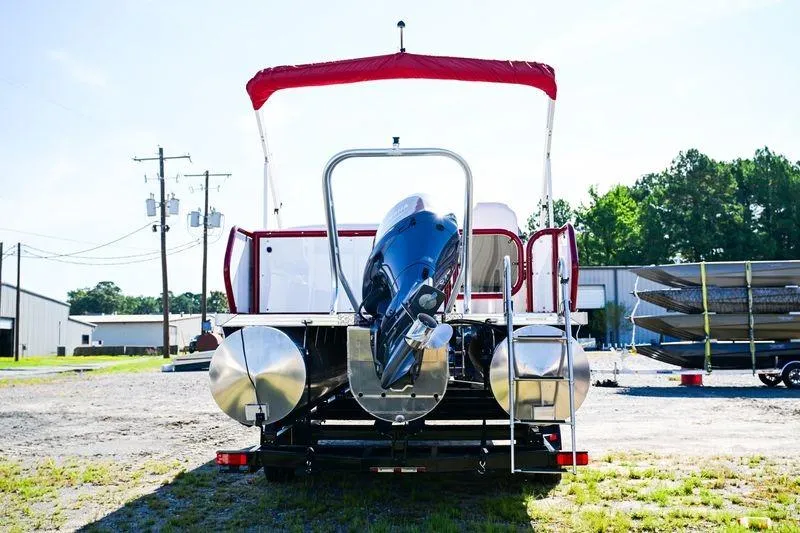 Slide: The Image of 2023 Aloha Pontoon Mahalo 23 with red canopy, rear view in outdoor setting. - 4