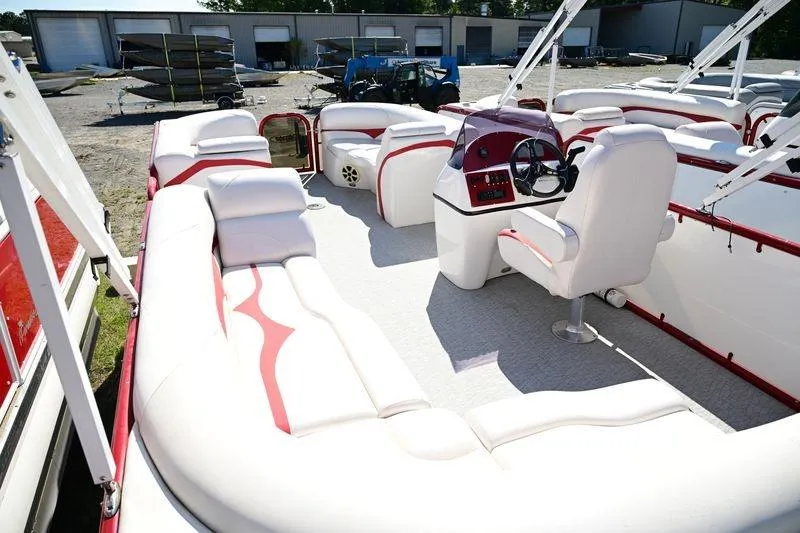 Slide: The Image of 2023 Aloha Pontoon Mahalo 23 interior with white and red seating, steering console, and spacious layout. - 8