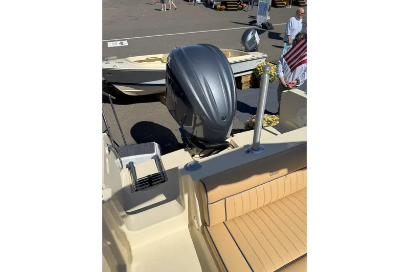 Slide: The Image of 2026 Rossiter 23 Classic boat with Yamaha outboard motor at a marina display. - 11