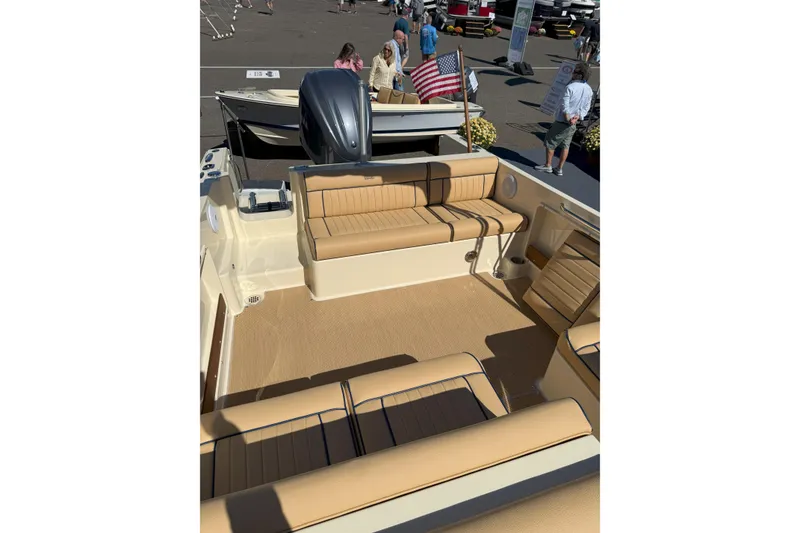 Slide: The Image of 2026 Rossiter 23 Classic boat interior with tan seating and American flag. - 3