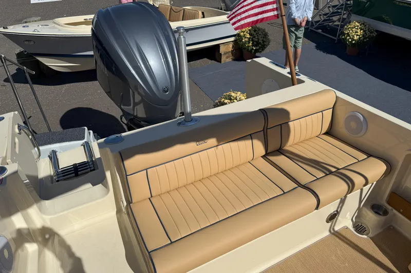 Slide: The Image of 2026 Rossiter 23 Classic boat with tan seating and American flag. - 4