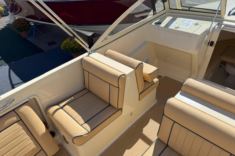 Slide: The Image of Interior of 2026 Rossiter 23 Classic boat with beige seating and sleek design. - 5