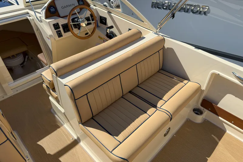 Slide: The Image of Luxurious interior of 2026 Rossiter 23 Classic boat with tan seating and Garmin controls. - 6