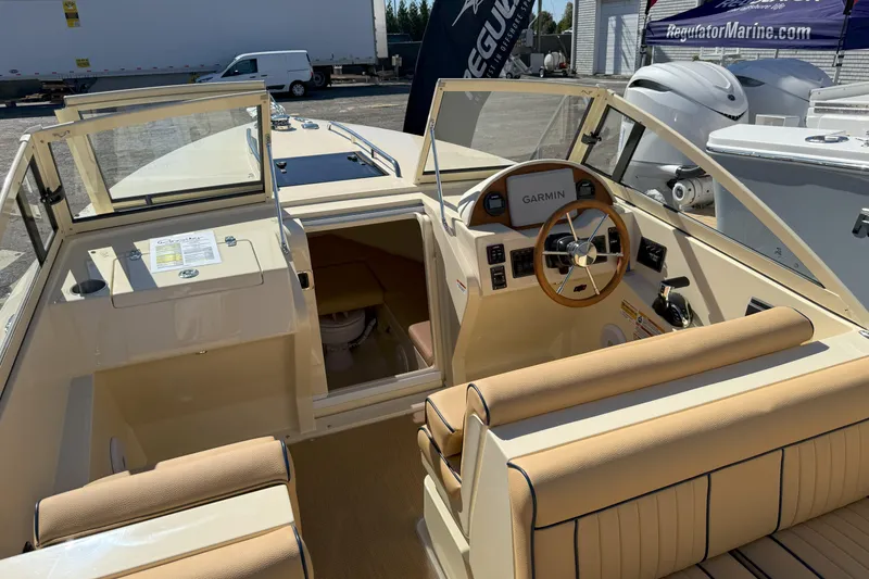 Slide: The Image of 2026 Rossiter 23 Classic boat interior with Garmin navigation and beige seating. - 7