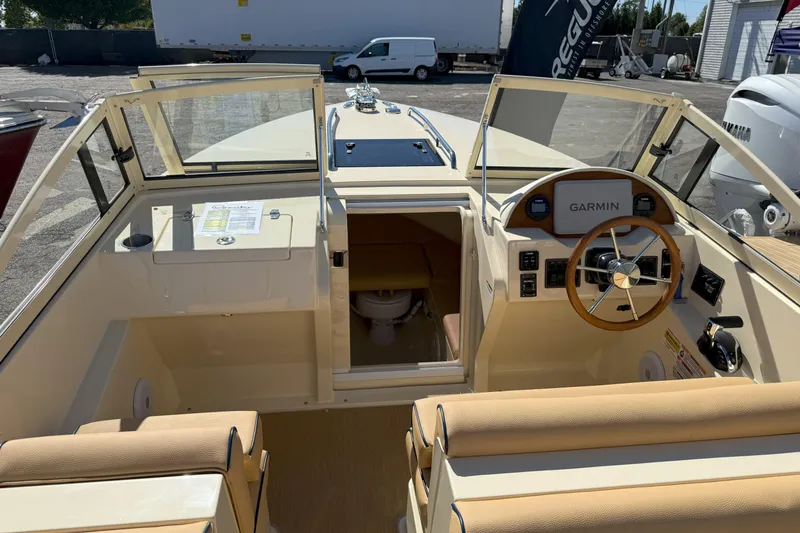 Slide: The Image of 2026 Rossiter 23 Classic boat interior with Garmin navigation and beige seating. - 8
