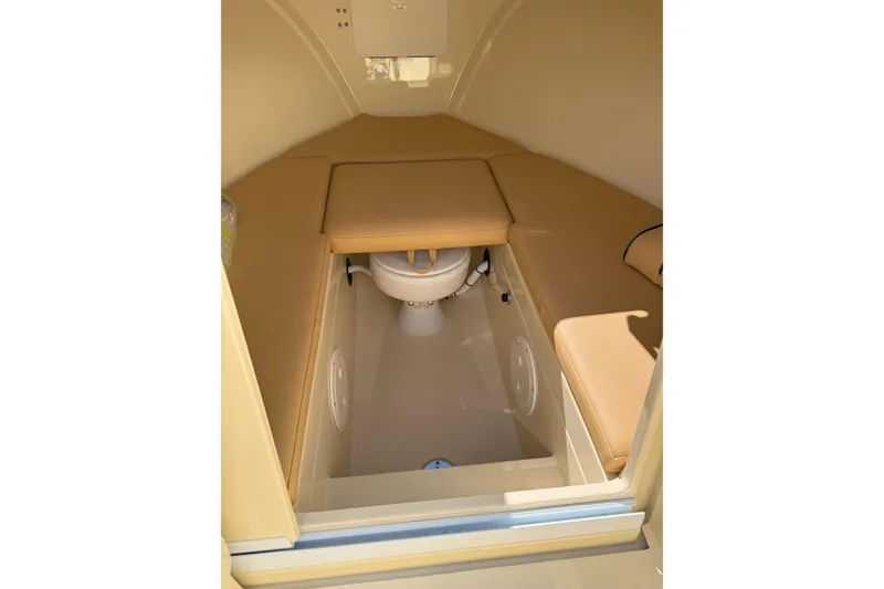 Slide: The Image of Interior of 2026 Rossiter 23 Classic boat with cushioned seating and compact toilet. - 9