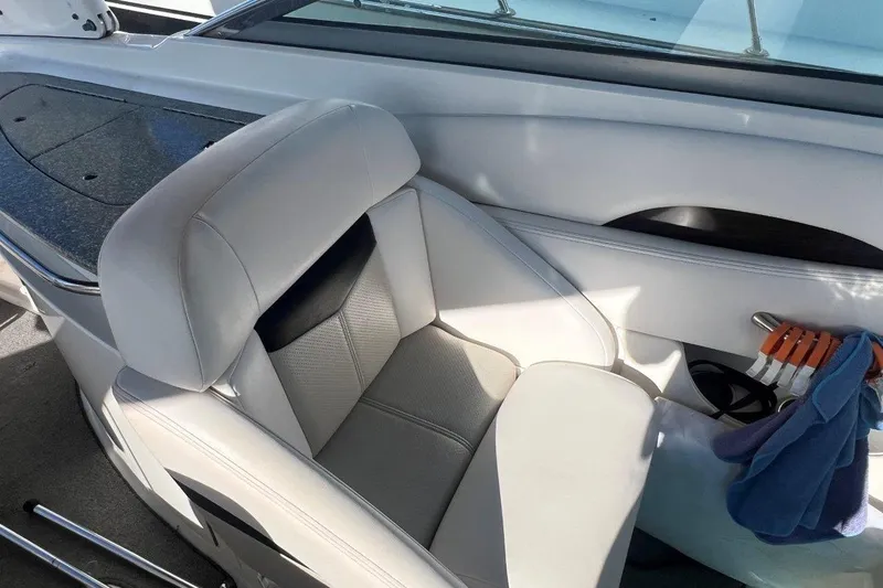 Slide: The Image of 2007 Chaparral 276 SSX boat interior with white leather seat and storage area. - 10