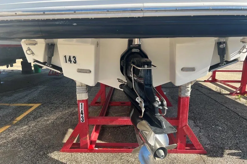 Slide: The Image of Rear view of a 2007 Chaparral 276 SSX boat on red stands. - 3