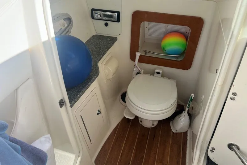 Slide: The Image of 2007 Chaparral 276 SSX boat bathroom with toilet, countertop, and colorful ball. - 7