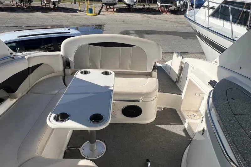Slide: The Image of 2007 Chaparral 276 SSX boat interior with seating and table, docked at marina. - 8
