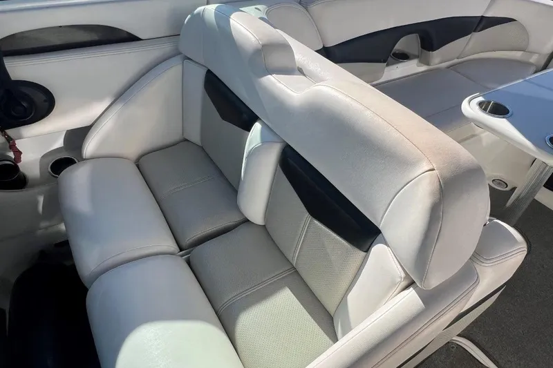 Slide: The Image of 2007 Chaparral 276 SSX boat interior with white leather seating and cup holders. - 9