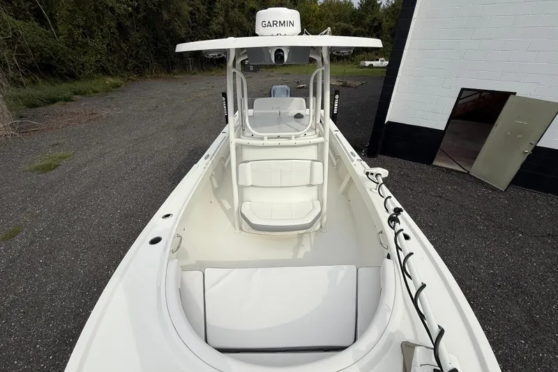 Slide: The Image of 2024 Parker 2300 Special Edition boat with Garmin equipment, docked near a building. - 12