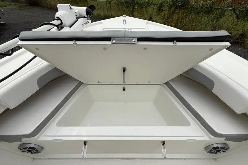 Slide: The Image of Open storage compartment on 2024 Parker 2300 Special Edition boat, featuring spacious interior. - 17
