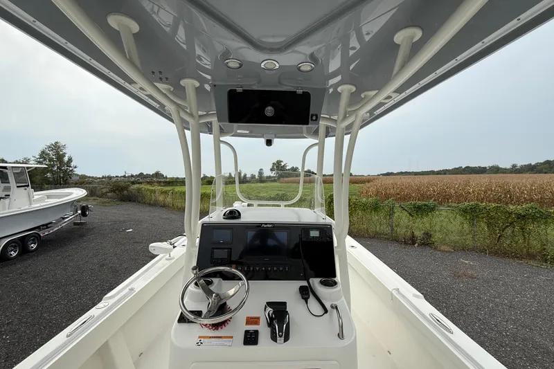 Slide: The Image of 2024 Parker 2300 Special Edition boat interior with steering console and navigation equipment. - 8