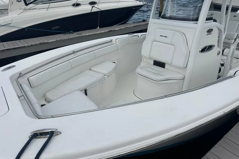 The Image of 2020 Sea Pro 259 Sport boat with white seating, docked at marina. - 3