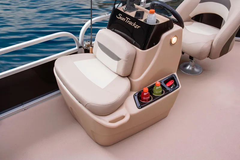 Slide: The Image of 2014 Sun Tracker Bass Buggy 18 DLX pontoon boat on trailer, parked on gravel road. - 3