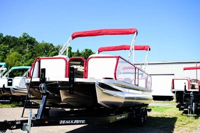 Slide: The Image of 2023 Aloha Pontoon Mahalo 23 with red canopy on trailer, outdoors. - 2