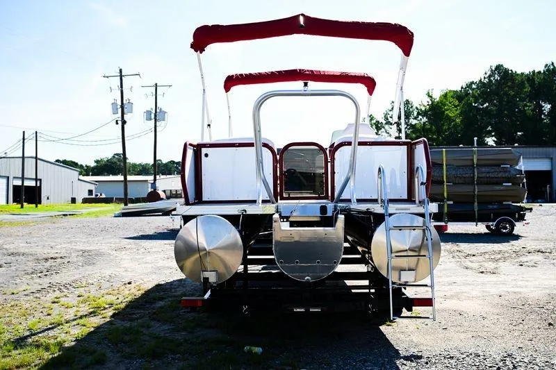 Slide: The Image of 2023 Aloha Pontoon Mahalo 23 with red canopy, parked outdoors. - 3