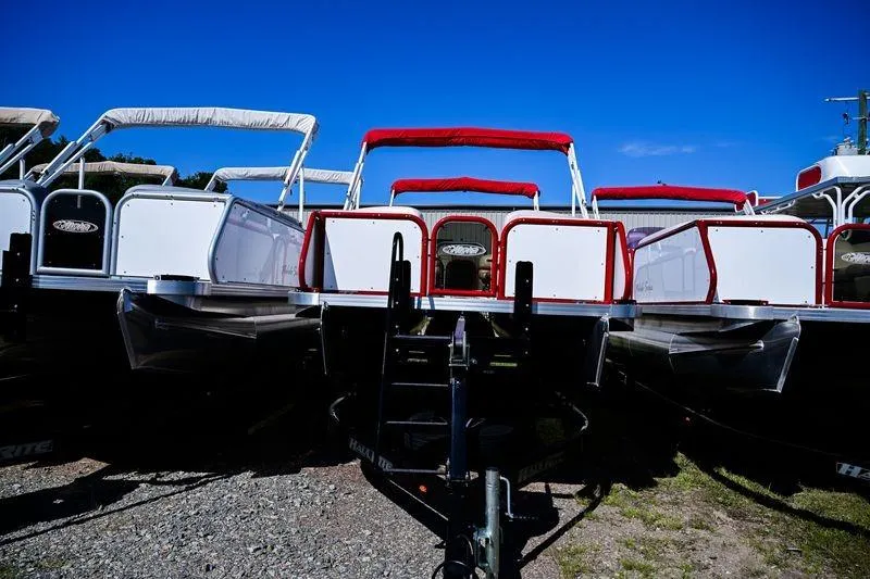 Slide: The Image of 2023 Aloha Pontoon Mahalo 23 boats with red canopies under clear blue sky. - 4