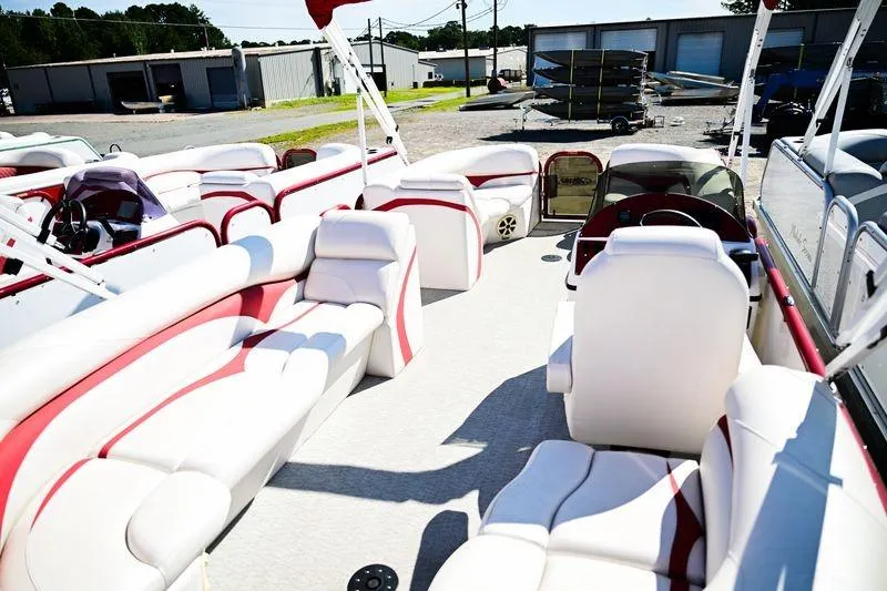 Slide: The Image of 2023 Aloha Pontoon Mahalo 23 interior with white and red seating, outdoor setting. - 6