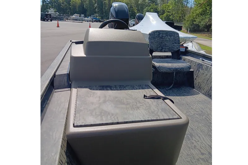 Slide: The Image of 2026 Tracker Grizzly 1754 SC boat interior with camo seating and steering console. - 8