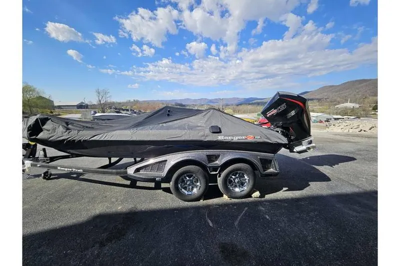 Slide: The Image of 2025 Ranger Z519 Garmin Ranger Cup boat covered, on trailer, with scenic mountain backdrop. - 4