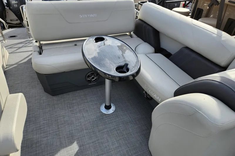 Slide: The Image of 2023 Sylvan X5 boat interior with cushioned seating and a central table. - 12