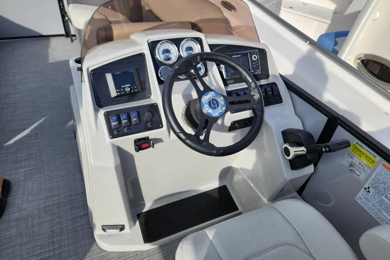 Slide: The Image of 2023 Sylvan X5 boat dashboard with steering wheel and control panels. - 14