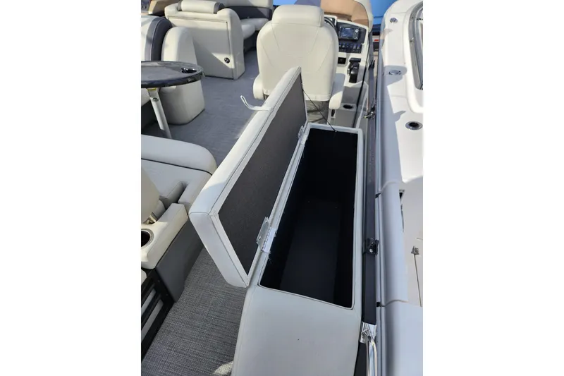 Slide: The Image of 2023 Sylvan X5 boat interior with open storage compartment and seating. - 9