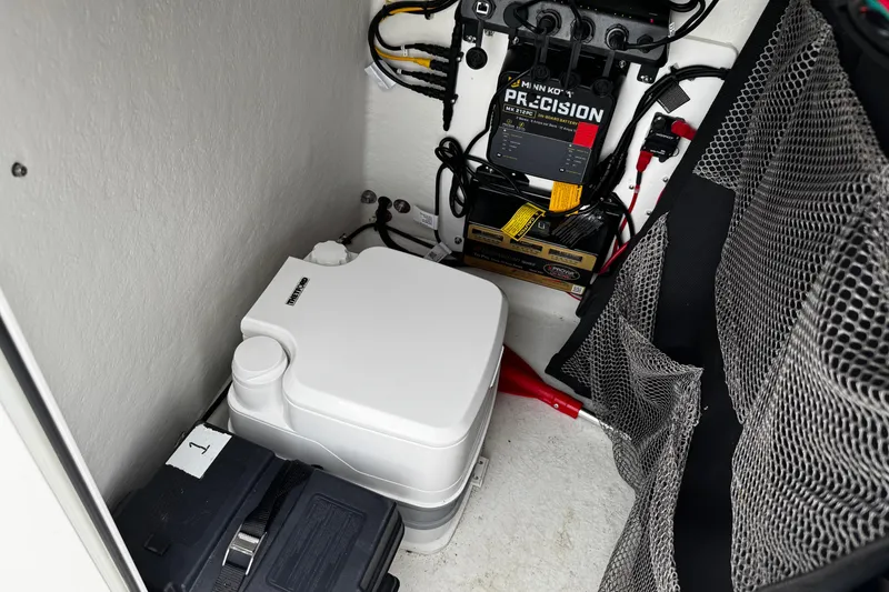 Slide: The Image of Interior of a 2021 Parker 2100 Center Console boat with equipment and storage. - 14