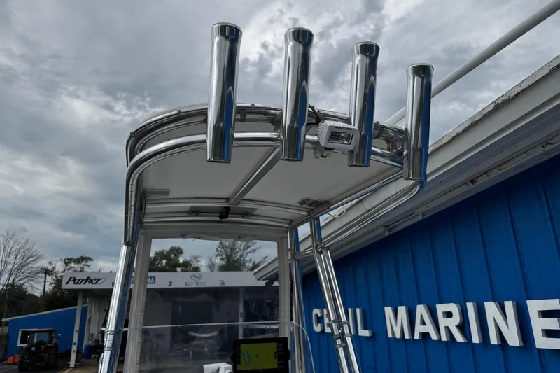 Slide: The Image of Parker 2100 Center Console boat, 2021 model, with rod holders, at a marine dealership. - 17