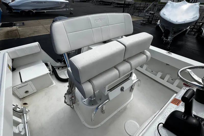 Slide: The Image of 2021 Parker 2100 Center Console boat interior with seating and steering wheel. - 25