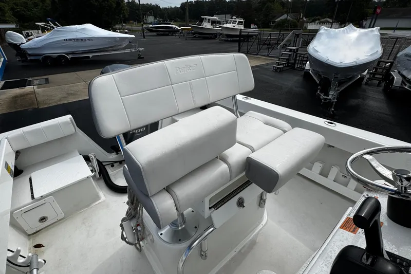 Slide: The Image of 2021 Parker 2100 Center Console boat interior with white seating and steering wheel. - 27