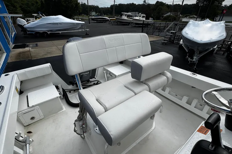 Slide: The Image of 2021 Parker 2100 Center Console boat interior with seating and steering wheel. - 28