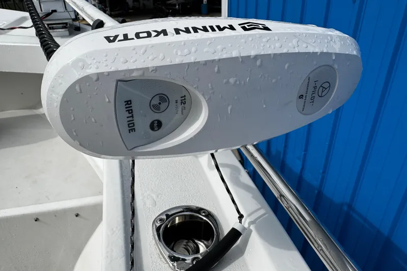 Slide: The Image of Minn Kota Riptide motor on 2021 Parker 2100 Center Console boat, wet with water droplets. - 32